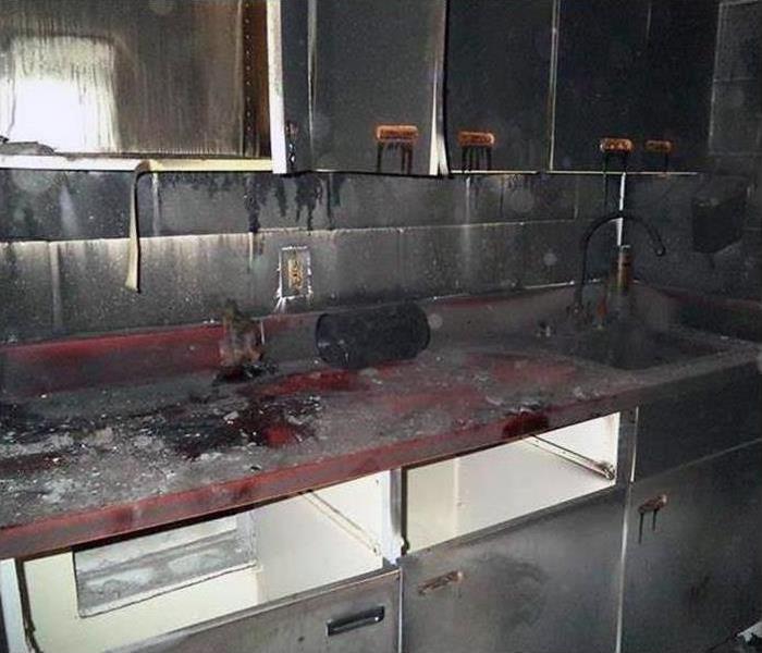 kitchen covered in soot after burning in a fire
