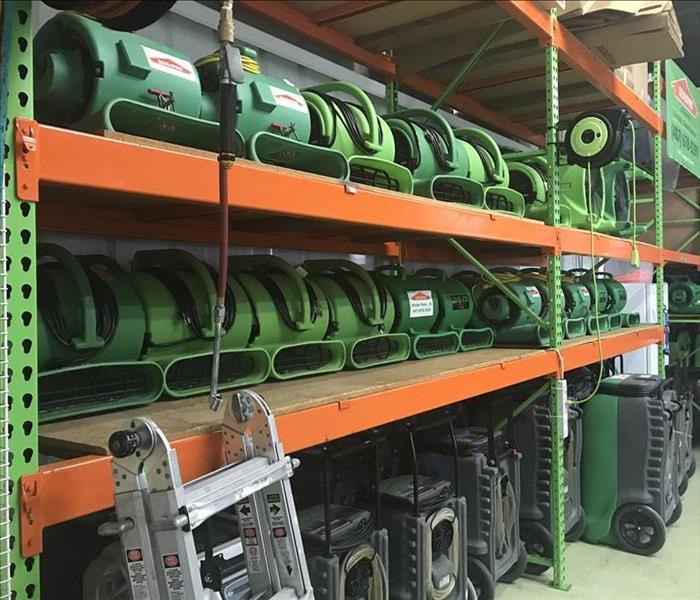 warehouse shelves full of green restoration equipment