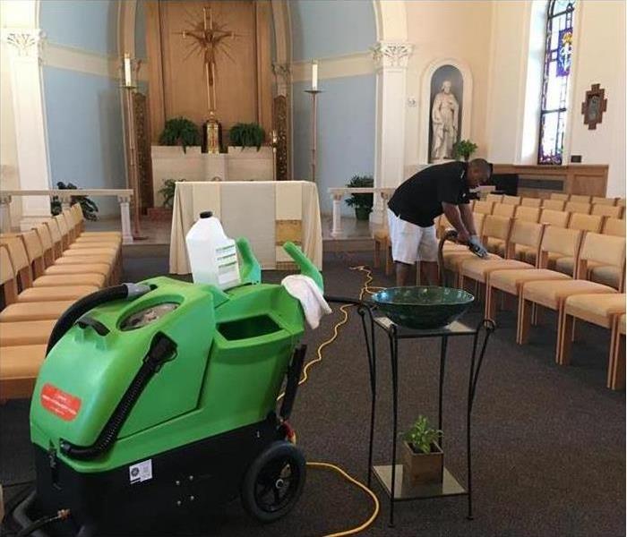 SERVPRO employee cleaning in a church